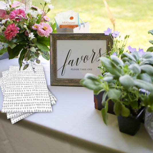 NEATsheets and NEATwipes on a table being displayed as wedding favors.