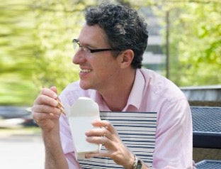 Man eating during the workday with a NEATsheets.
