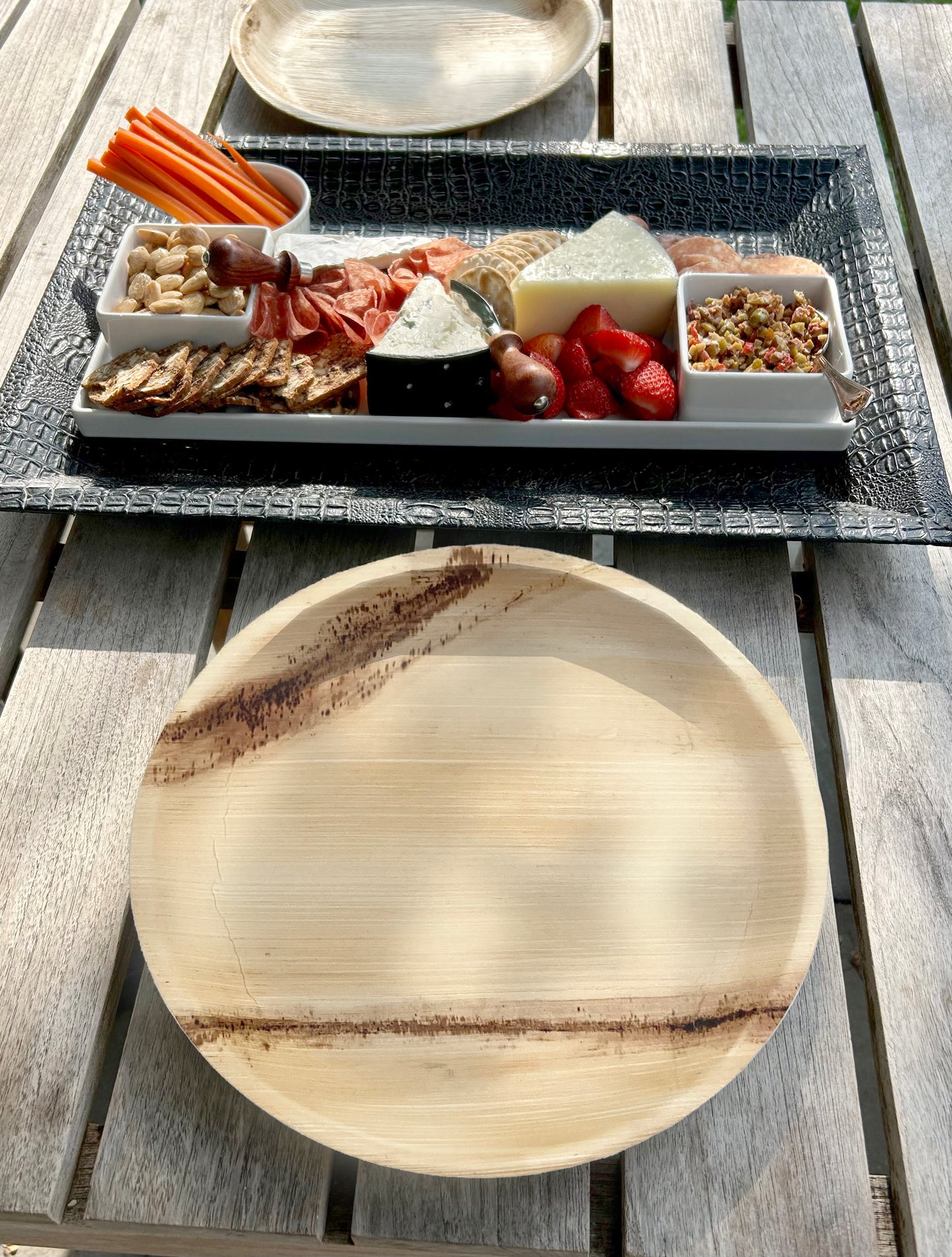 NEATtable compostable palm leaf plate at an outdoor dinner.