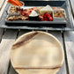 NEATtable compostable palm leaf plate being used an outdoor dinner