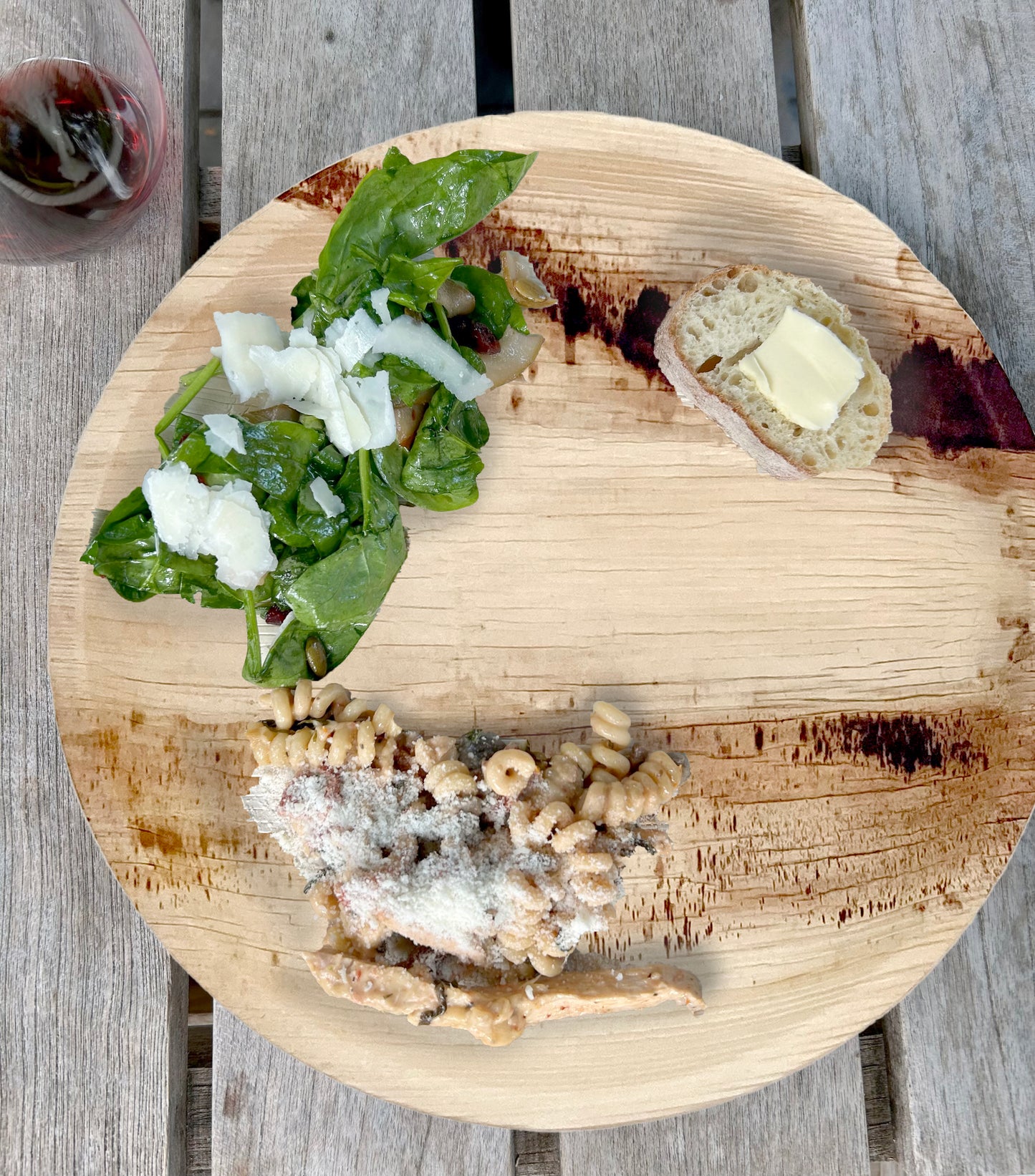 NEATtable compostable palm leaf plate being used for an outdoor dinner