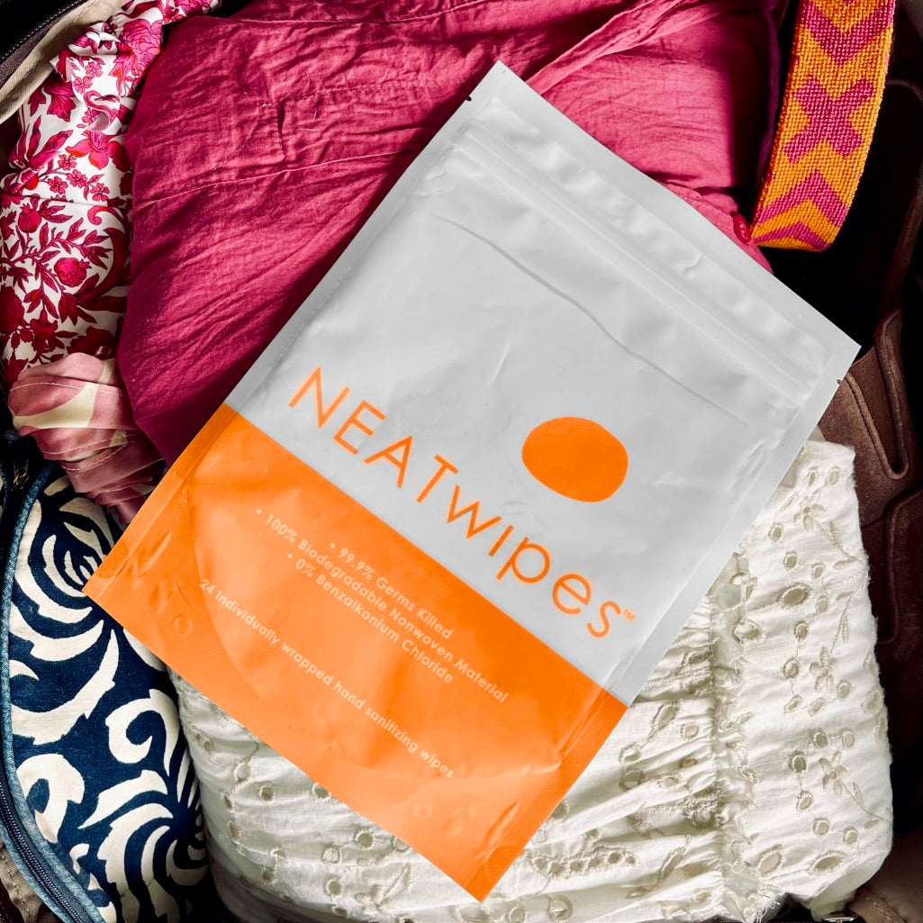 A 24-Count pouch of NEATwipes Fresh Citrus hand wipes in a travel bag.