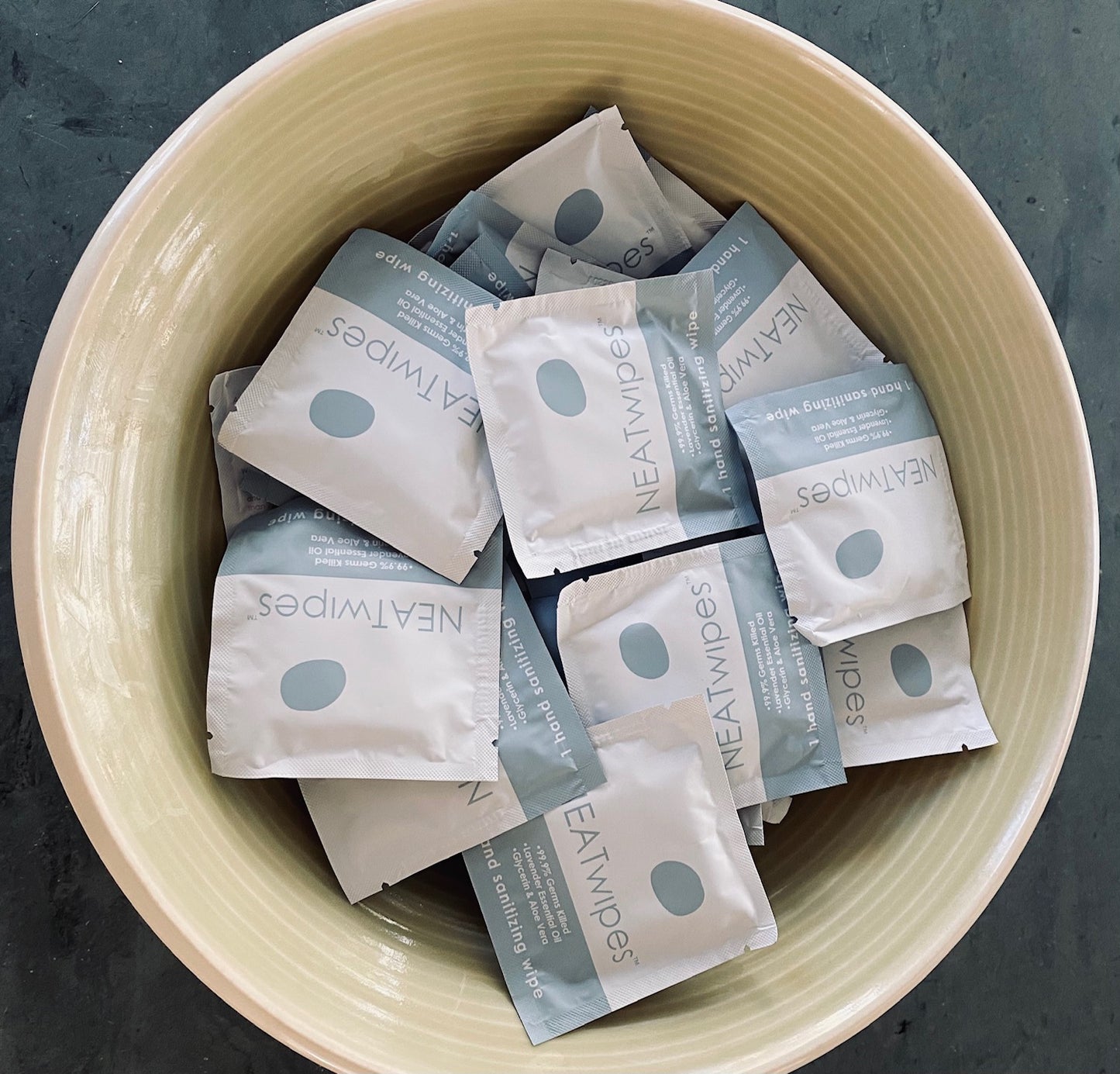 NEATwipes Lavender hand wipes in a ceramic bowl.