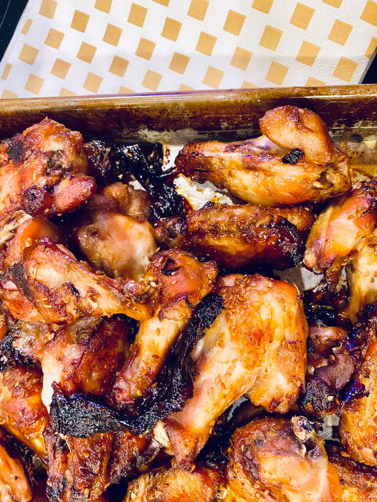 Golden brown chicken wings on a tray with a Khaki NEATsheet.