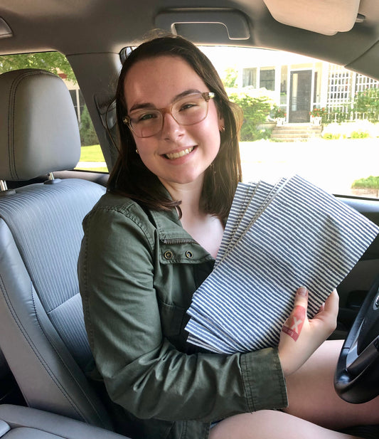 Abby Tutterow, NEATGOODS' Summer Associate, in her car with NEATsheets.