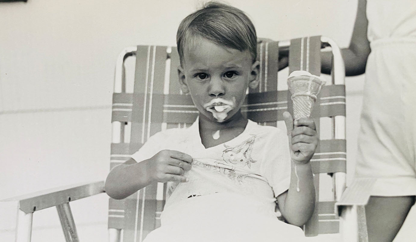 A picture of young boy eating an dripping ice cream cone as part of the NEATGOODS story.